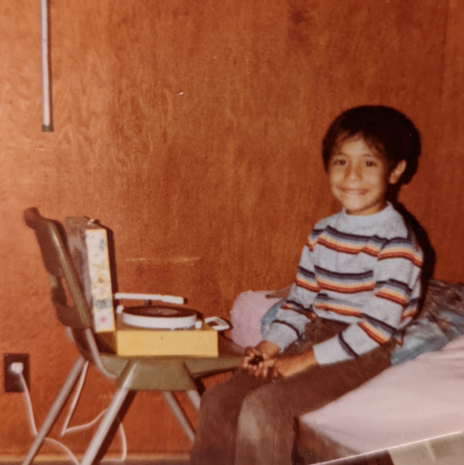 Picture of Carlos as a child sitting down and listening to a record. #ADHD
